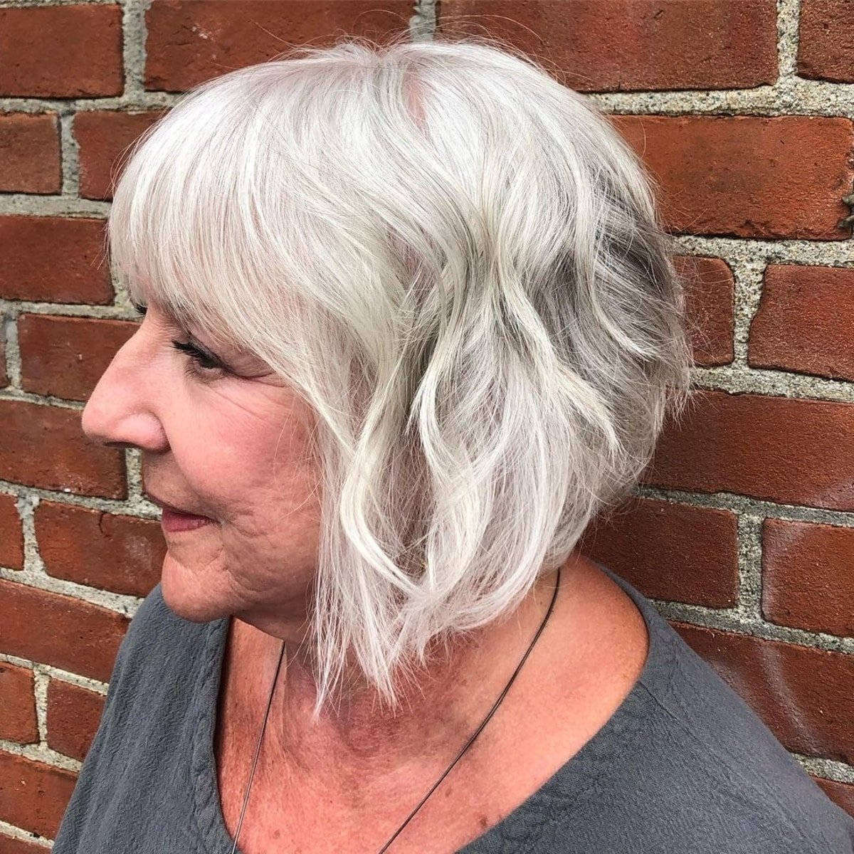 Flattering Angled Bob for Grey Hair with Full Bangs