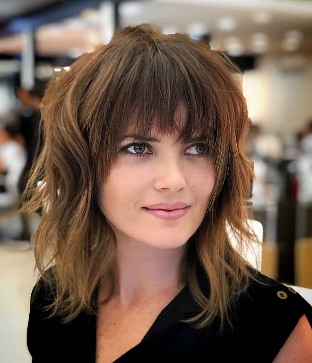 Perfect dark wavy angled bob with wispy bangs