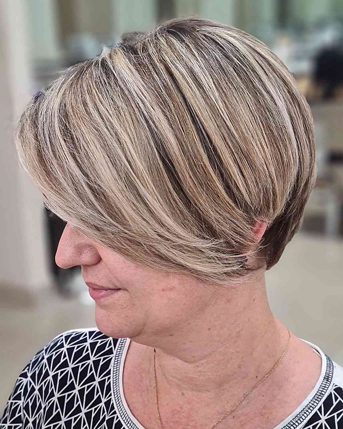 Cheek-Length Dimensional Short Pixie Bob with Blonde Highlights on Mature Women