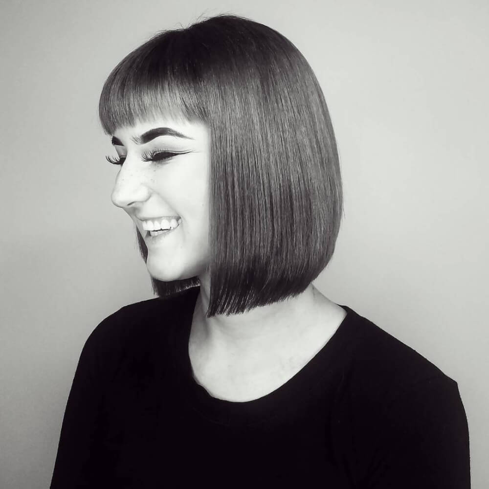 A clean symmetrical Bob haircut with bangs for thin hair