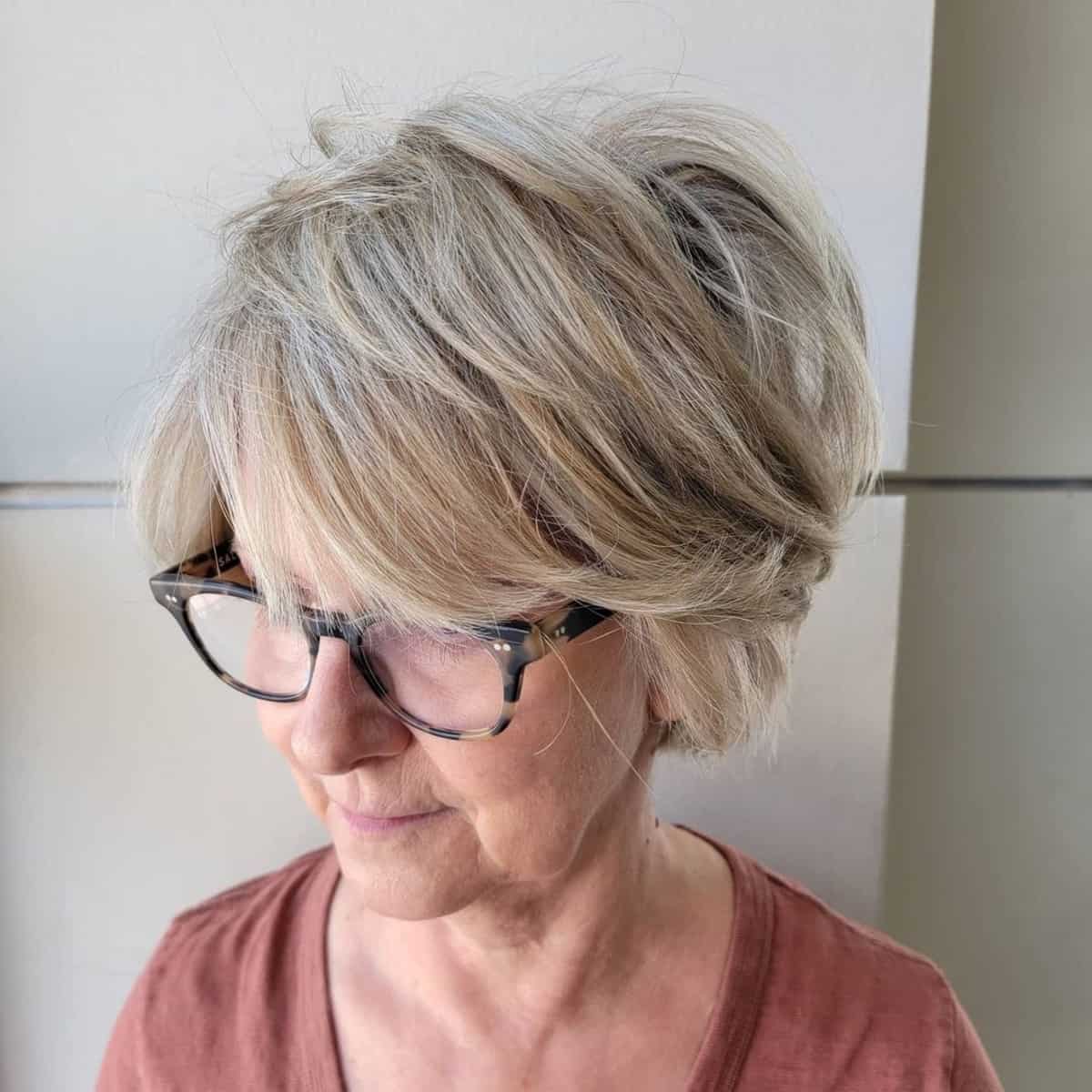 Tousled razor cut bob with glasses for ladies in their 60s