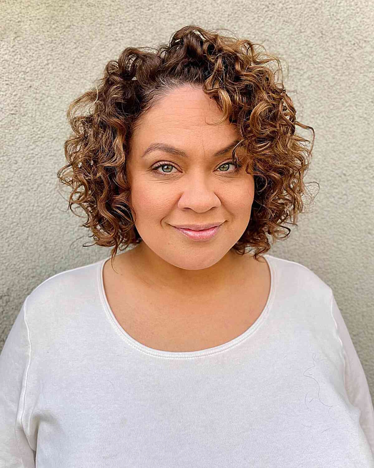 Short Side-Parted Curly Bob Cut for women with large foreheads and prominent cheeks