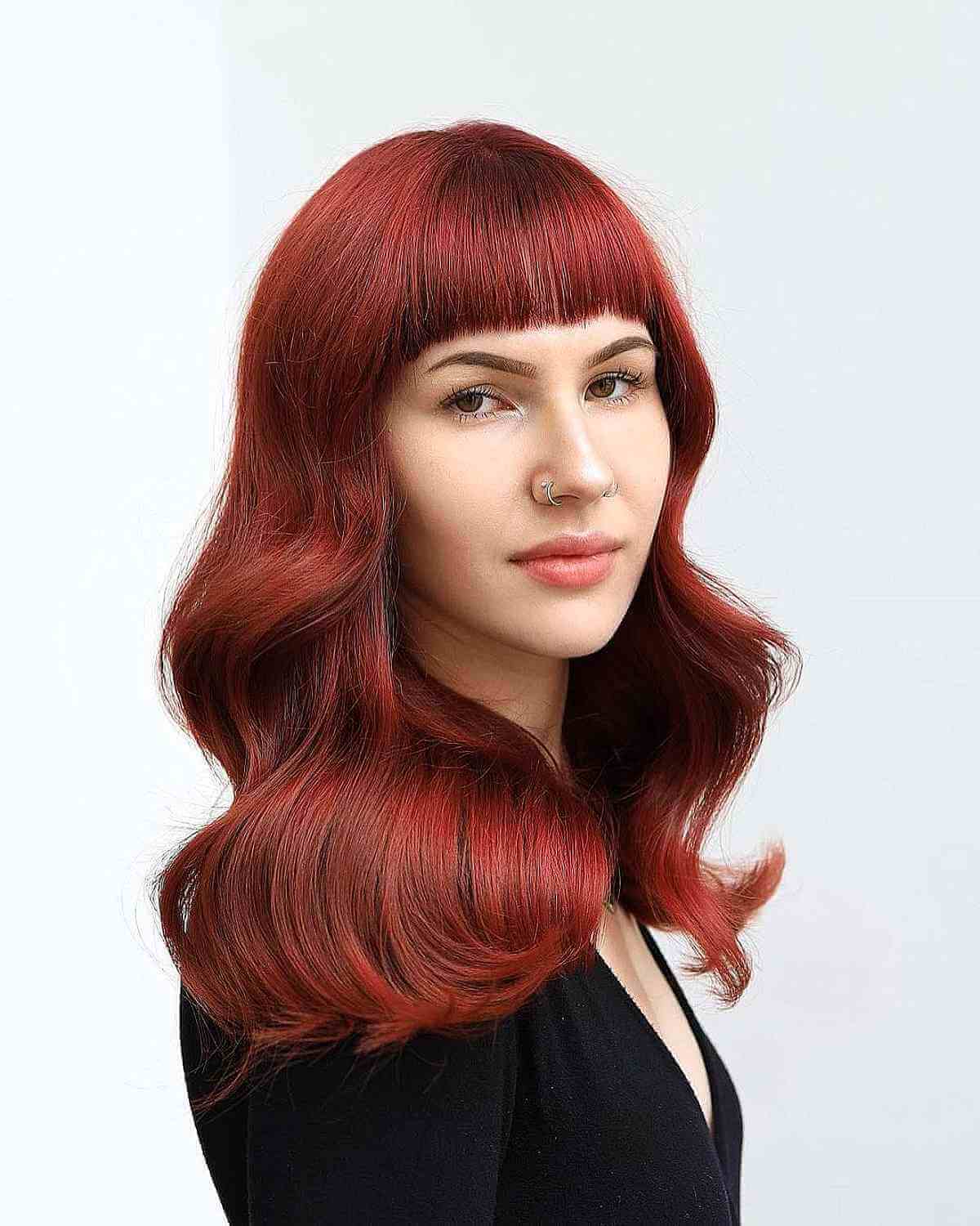 Wavy Red Hair with Blunt Bangs